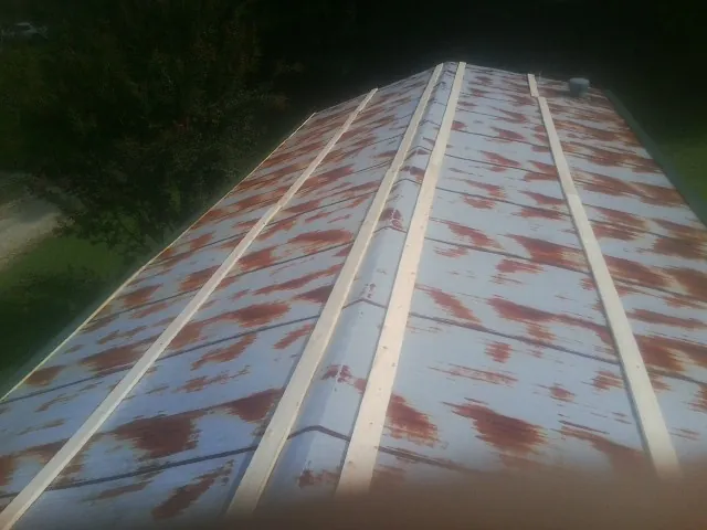Rusted metal roof panels with new wood purlins before replacement — Storm Damage Roof Repair in Mustang by Roofing Brothers